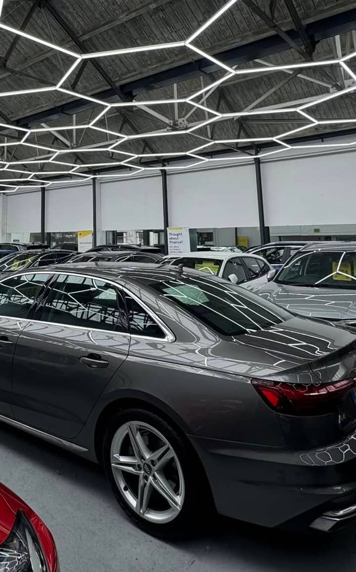 The W Jones showroom on Lennox Street, Bognor Regis — cars parked indoors under the hexagonal LED ceiling