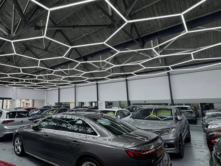 Cars parked inside the W Jones showroom under its hexagonal LED ceiling